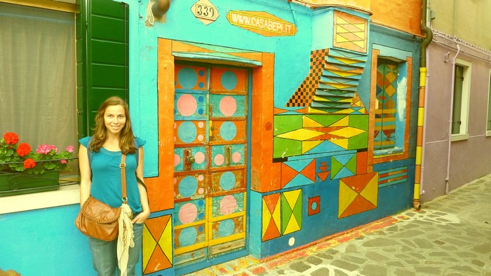 Ana next to a colourful house on Burano